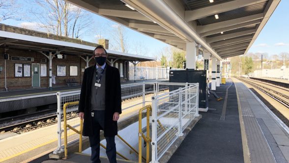 Man in face mask on train platform