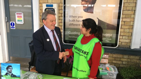 Man and woman shake hands at mental health hub