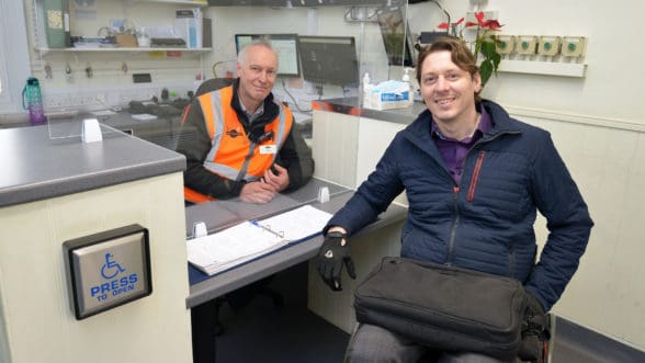 Carl Martin, Accessibility Lead, at the information point, and staff member Tim Hawkins at station.